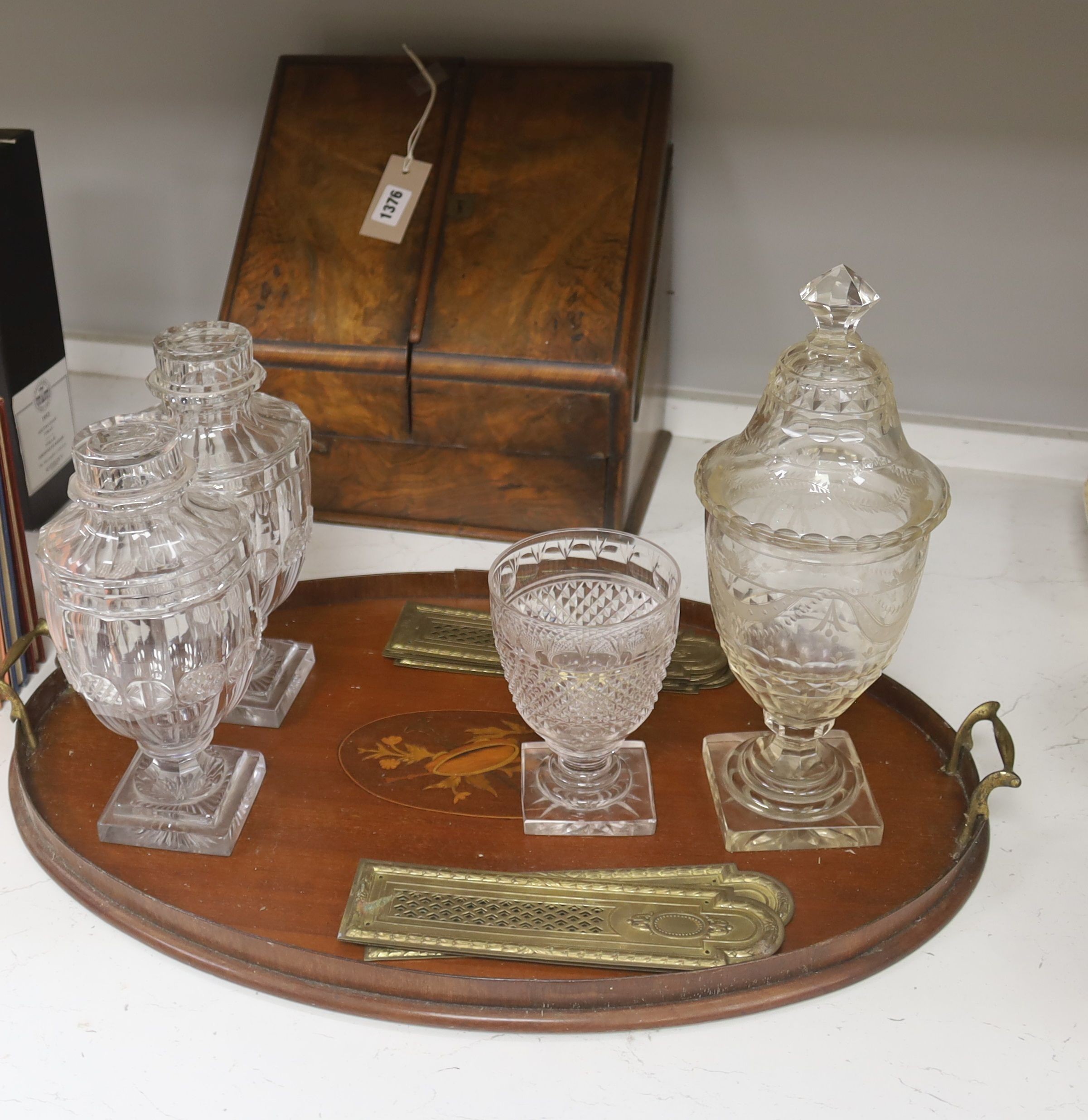 A Victorian walnut stationary cabinet, an Edwardian inlaid oval tray and a group 7 brass fingerplates